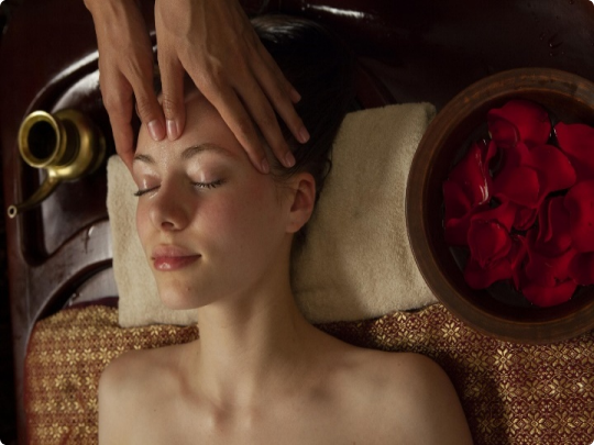 Client enjoying relaxing botanical facial massage and acupressure ritual