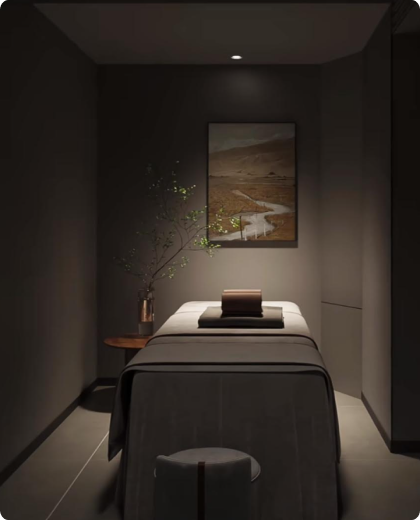 Serene treatment room with ambient honeyed lighting and prepared massage table