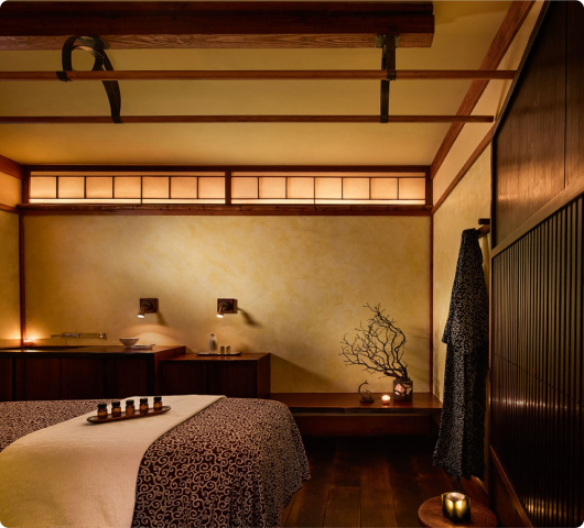 Serene private treatment room with warm ambient lighting and plush linens at LUX Spa